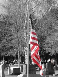 American flag (color) and historic cemetery (black and white)