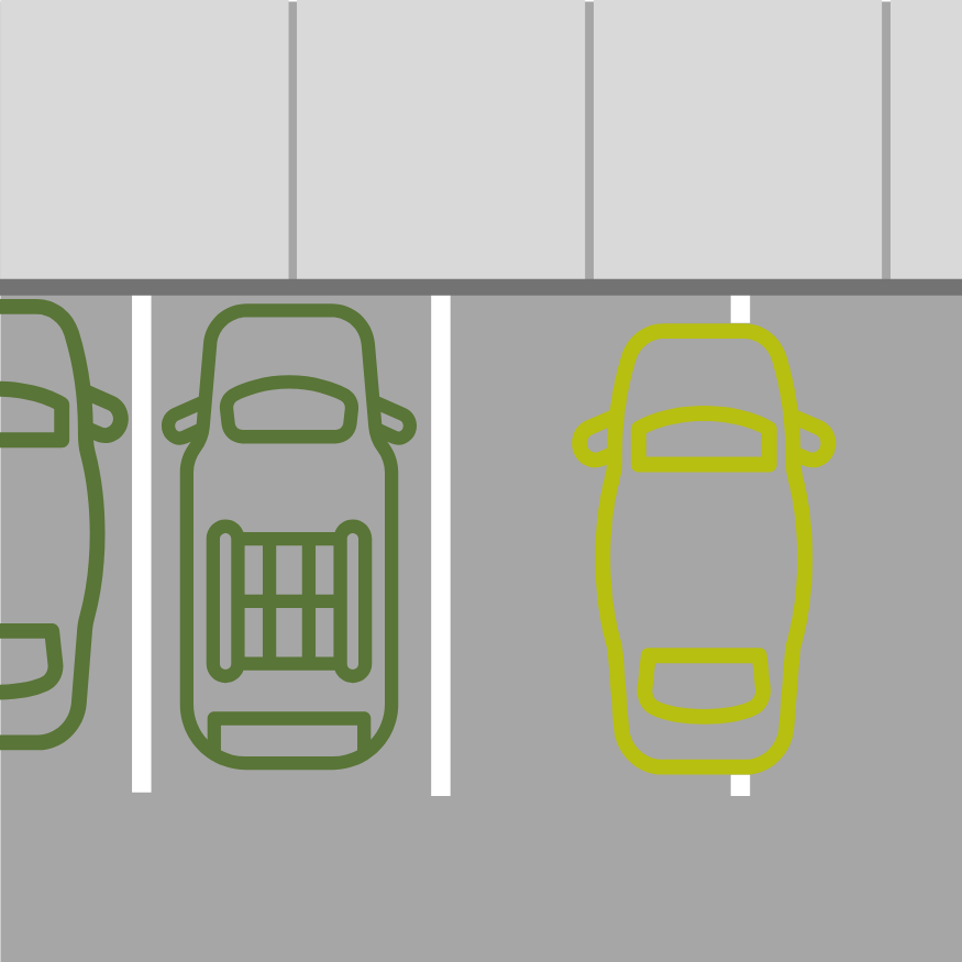 A vehicle is parked across two space lines next to other vehicles.
